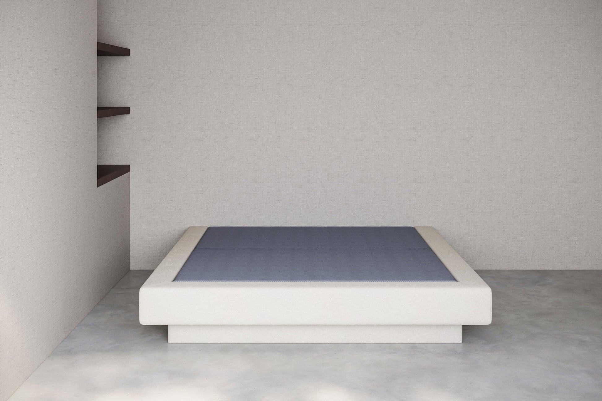 Minimalist white platform bed with anti slip base against a plain wall.