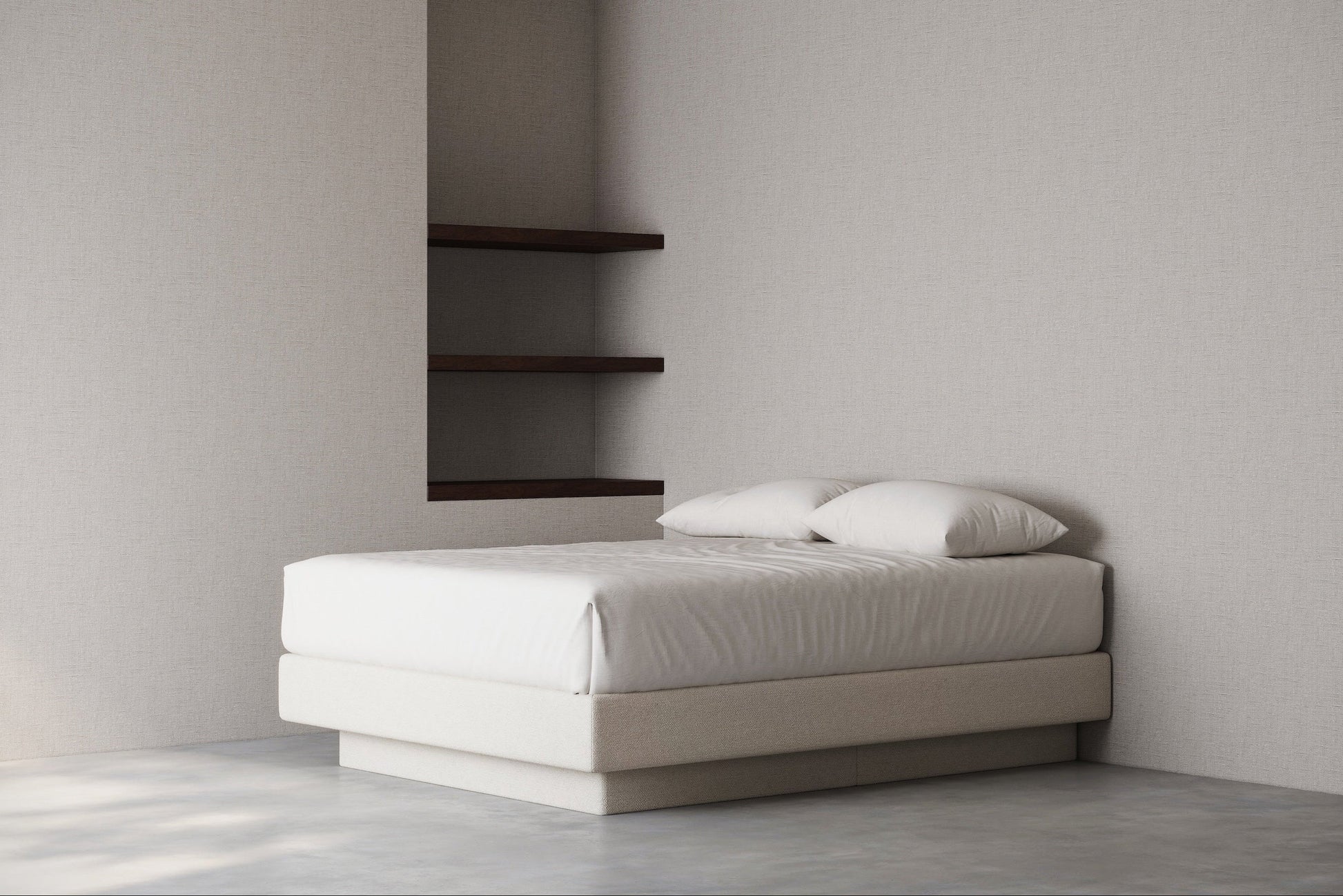 Minimalist bedroom with a bed base against a plain wall