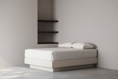 Minimalist bedroom with a bed base against a plain wall